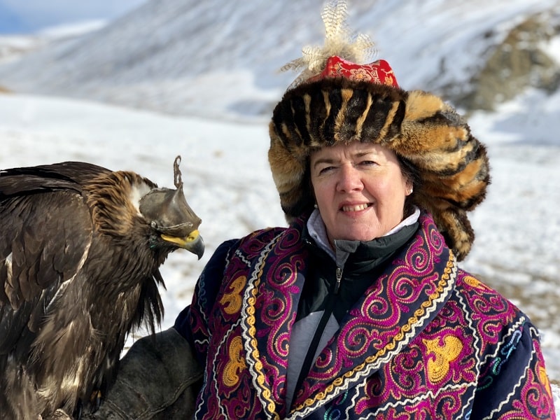 client posing with golden eagle for photo