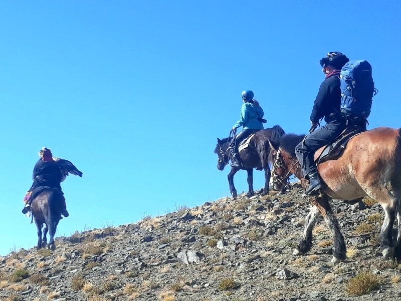 riding to mountain top for experiencing hunting with golden eagle